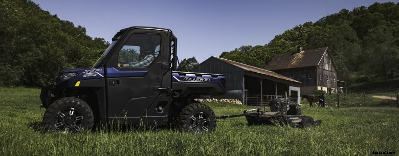Ranger XP 1000 Northstar pulling a mower on a ranch